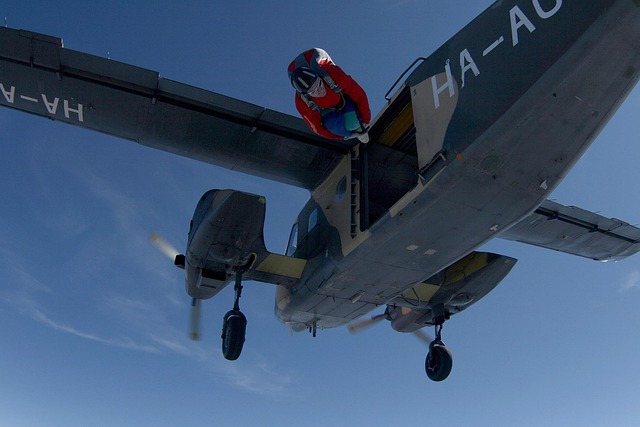 Skydiver exiting aircraft in jumpsuit